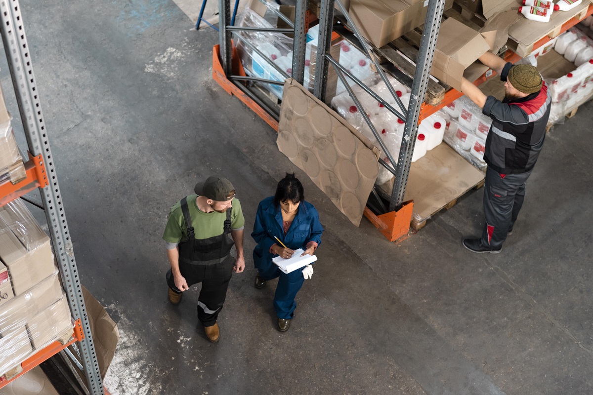Workers going through a warehouse maintenance checklist