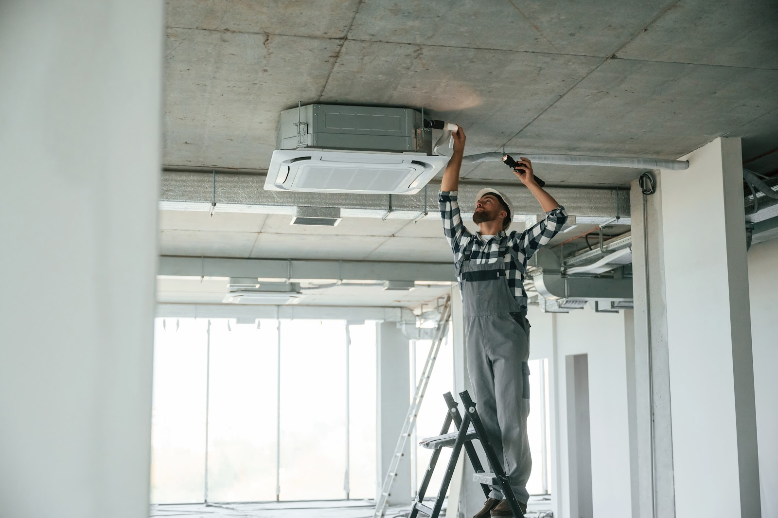 man fixing a HVAC system