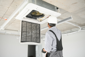 man fixing a commercial HVAC