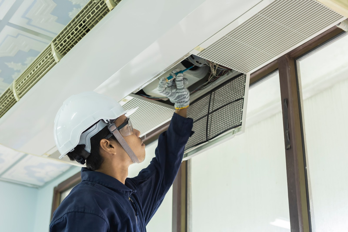 Technician fixing an HVAC system